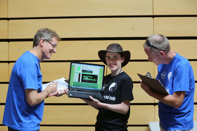 Participant Con from Cork City pictured showing his reforestation app creation to Intel judges Brendan Cannon and Stephen Blott. Credit: Conor McCabe Photography