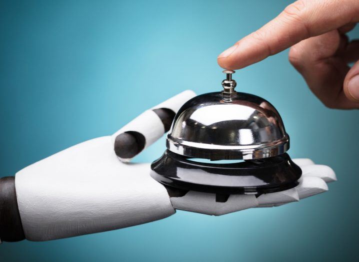robot holding a reception bell