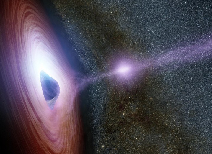 Artist’s concept of a supermassive black hole, surrounded by a swirling disk of material falling onto it. The purplish ball of light depicted launching from the black hole is its corona. The launch of the corona may generate an X-ray flare, via NASA/JPL-Caltech.