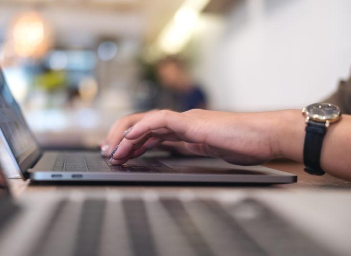 Woman typing on laptop. Human error is a massive cyber risk in the workplace