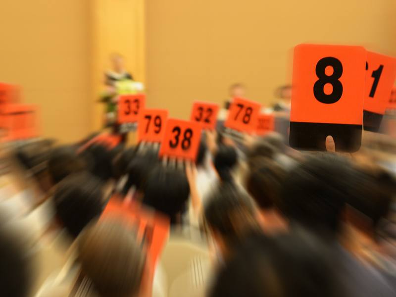 people bidding at an auction