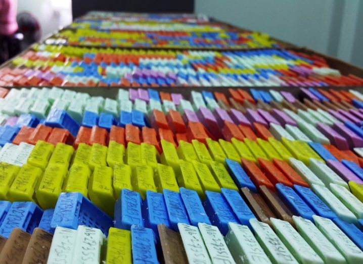 Row of multicoloured clinical files stretching far into the distance.