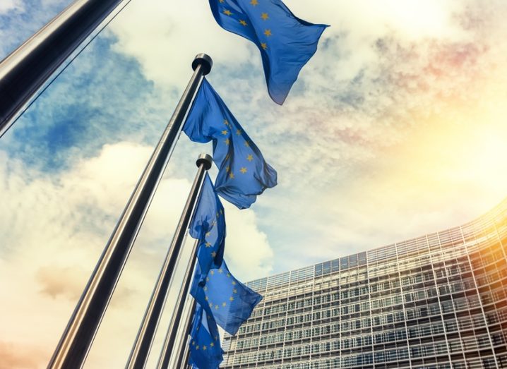 Waving EU flags outside the European Commission in Europe.