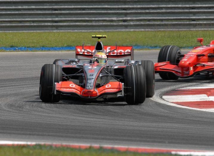 vodafone race car rounds bend on track.