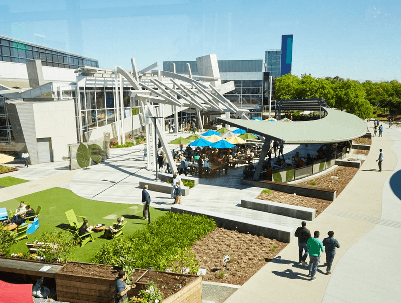 Aerial view of the Googleplex, Google's main campus in Mountain View, California. Employees walking outside.