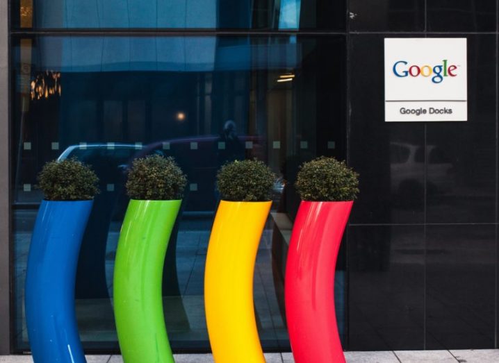 Four plastic plant containers in blue, green, yellow and red outside a Google office in Dublin.