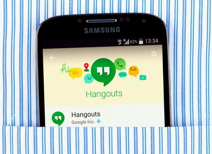 google hangouts app on a the screen of a Samsung phone in a stripey shirt pocket.