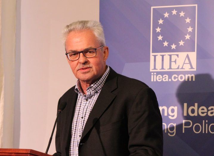 DARPA's David Gunning in a black suit jacket standing at the IIEA podium.