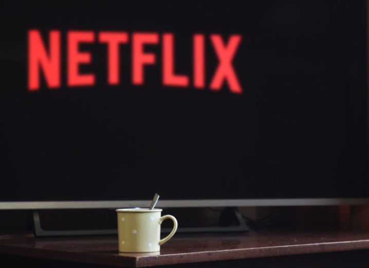 A warm drink in front of a TV screen with Netflix on display.