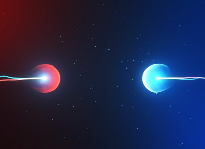 Abstract shot of a red particle hurtling towards a blue particle.