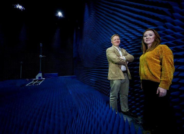 Ronan Farrell and Méabh Loughman looking at the camera while standing and smiling in the RadioSpace lab.