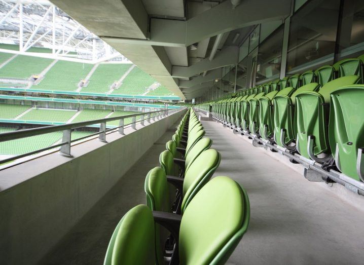 Long row of green fold-out seats in the Aviva Stadium in Dublin.