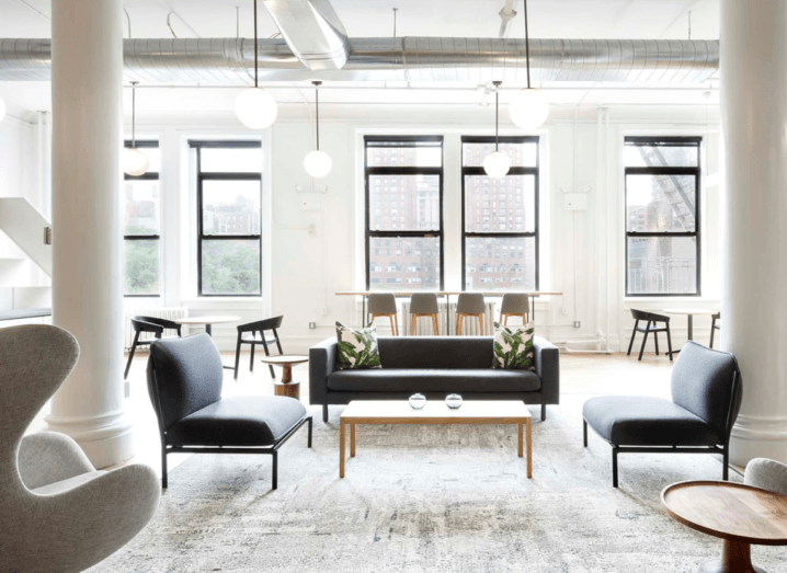 A bright, modern Knotel workspace, with minimalist furniture and large windows.