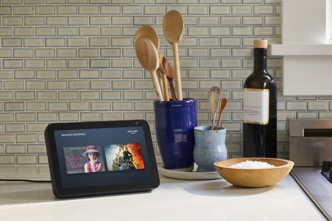 A portable screen displaying Amazon Prime Video content pictured on a countertop next to some kitchen utensils.