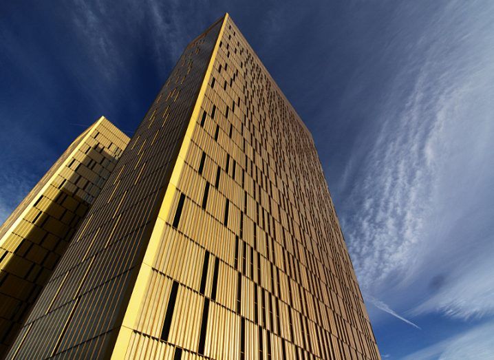 View of gold façade of European Court of Justice building taken from below on a bright day.