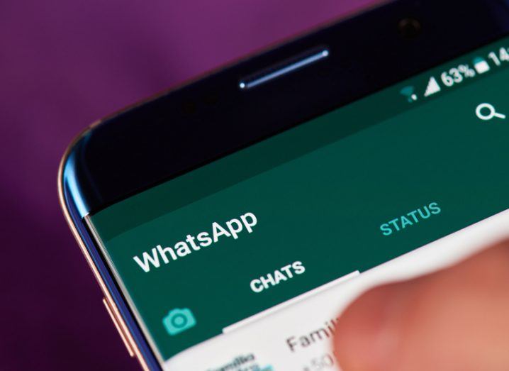 View of green and white display of WhatsApp app loaded up on smartphone screen.