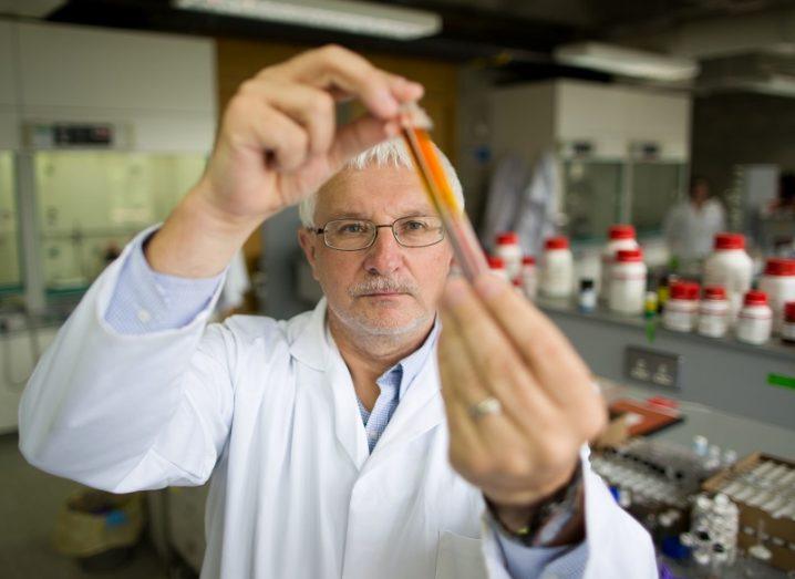 Prof Michael Zaworotko in a white coat in his lab holding up the material.