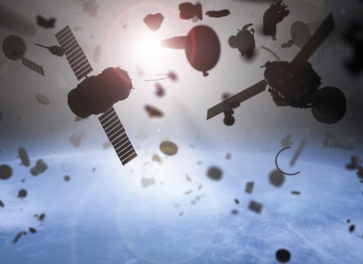 Space junk in orbit, with satellites and other materials floating above a blue planet.