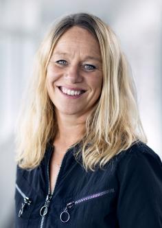 Headshot of Kristine van het Erve Grunnet in a dark navy top.