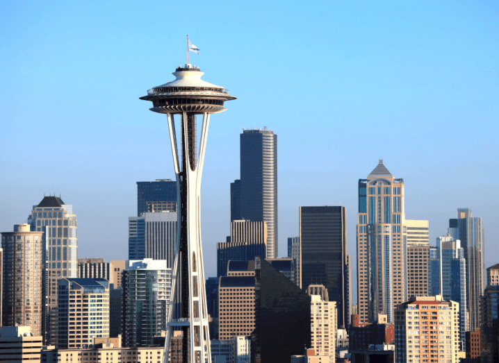 The skyline of Seattle, featuring recognisable structures in front of a blue sky.