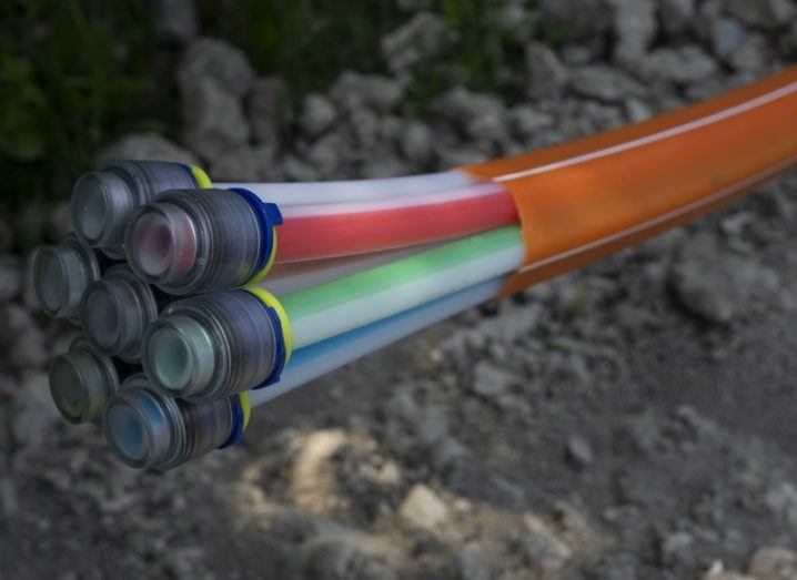 Close-up of a split fibre-optic cable coloured orange.