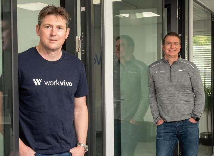 John Goulding and Joe Lennon standing and smiling in the Workvivo office.