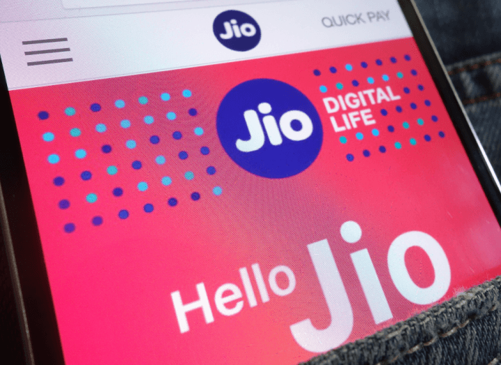 The Jio website displayed on a smartphone in a back pocket of a pair of jeans.