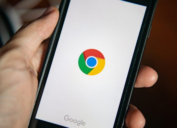 A close-up image of the Google Chrome app being opened on a smartphone.