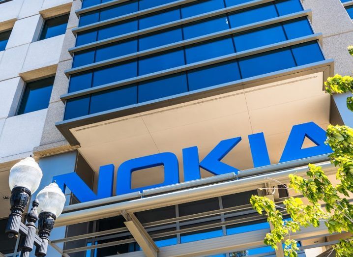 Looking up at the Nokia logo on the side of a tall, glass building.