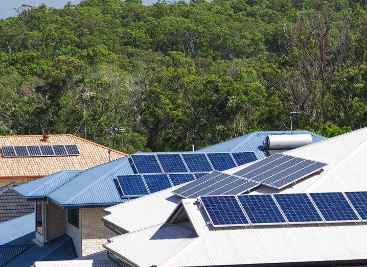 Solar panels on the roofs of three houses.