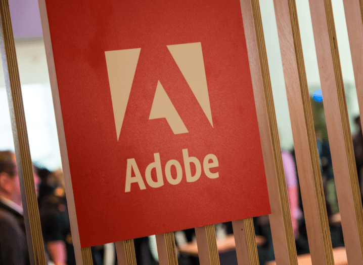 The Adobe logo displayed on a wooden panelled wall.