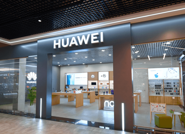 A Huawei storefront. Inside the shop there are tables with smartphones and other devices on display.