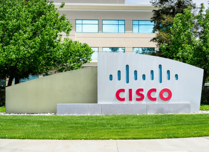 The Cisco logo on a large, stone plaque outside of an office building.