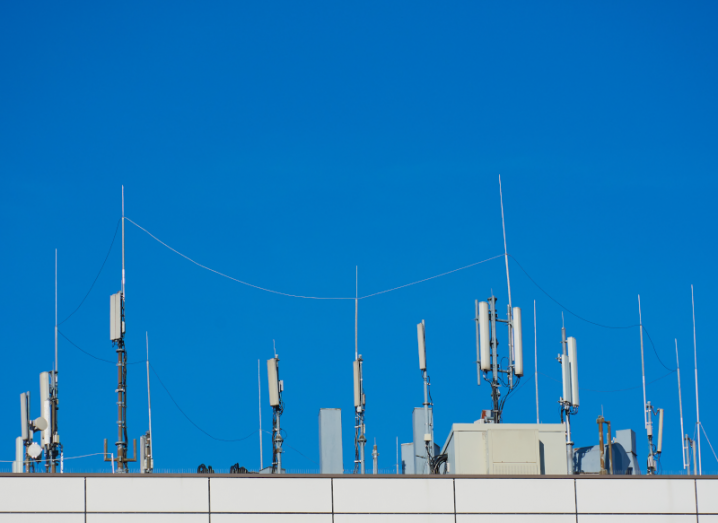 A blue sky above phone masts.