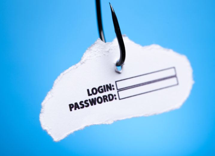 A fishing hook is hanging against a blue background with a piece of paper asking for login and password details, symbolising phishing and email scams.