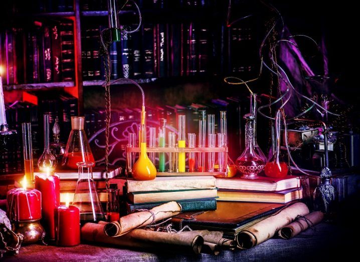 Beakers and lab equipment shrouded in red light and darkness.