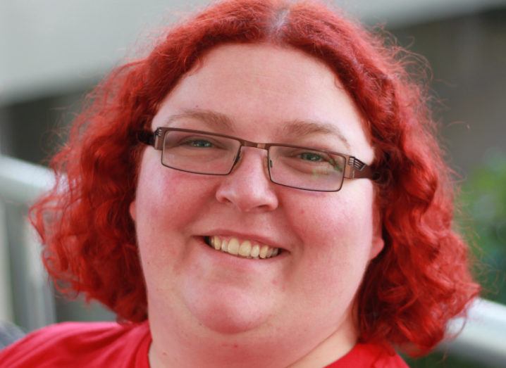 A close-up image of Meri Williams, who has bright red hair and glasses.