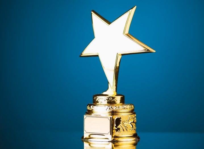 Trophy with a large gold star against a blue background.