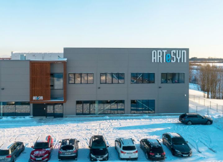 A large grey building with the Artesyn logo pictured on a winter’s day with snow covering the surrounding area.