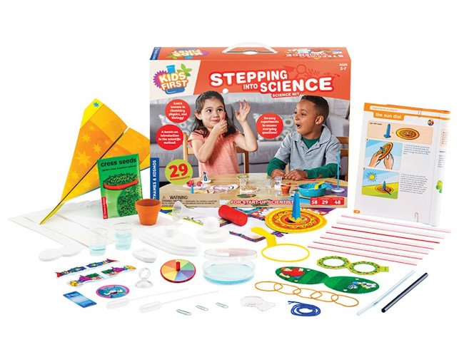 A kids' science experiment box with a lot of accompanying items spread out on display.