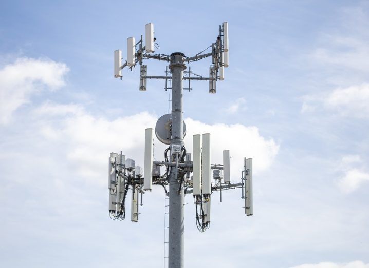 5G tower against a cloudy sky background.