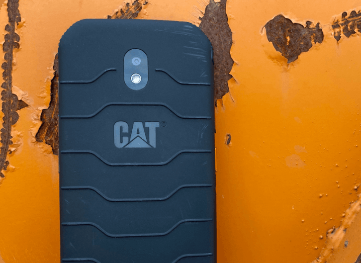 The rear of a rugged smartphone with a textured grip, bearing the Cat logo.