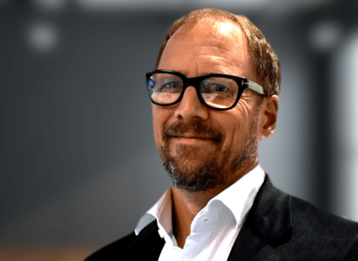 A headshot of Lucas Hendrich against a blurred-out office background.