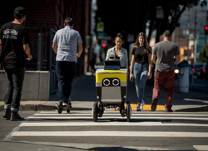 Serve's delivery robot crossing the street.