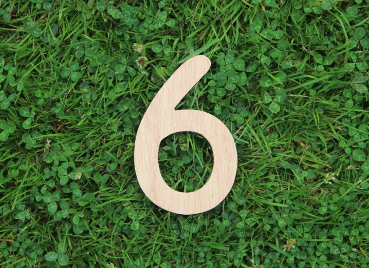 Wooden number six lying on a bed of grass to symbolise the six tips for getting funding.