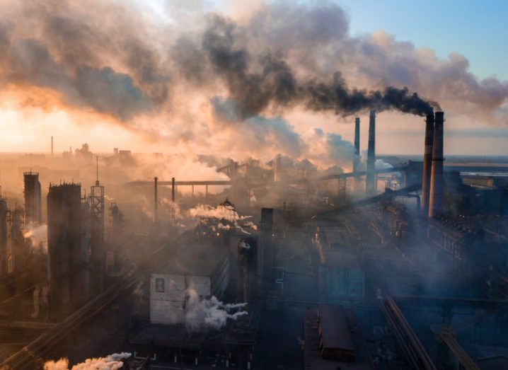 Aerial view of a large industry plant with several plumes of smoke polluting the air with CO2 emissions.