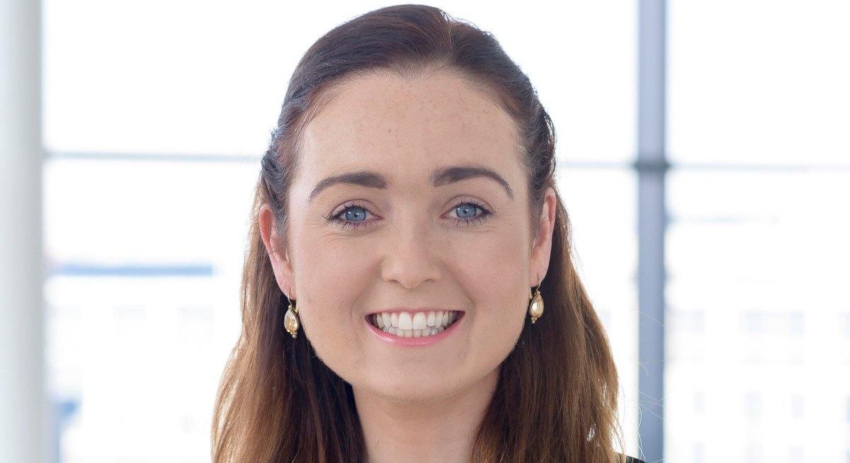 Dr Orna Fennelly of ICHEC is smiling into the camera in front of a brightly lit window.