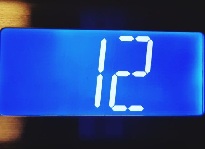 Close-up of a digital number 12 on an elevator display.