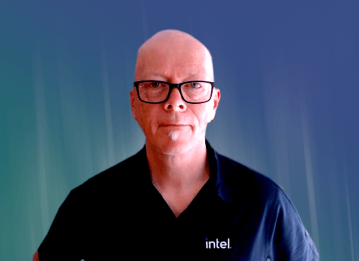 A man in a T-shirt that says Intel sits in front of a camera.