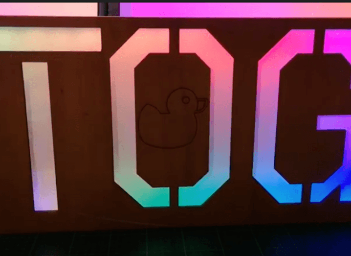 A sign that spells out Tog in large letters, lit up by multicoloured lights.